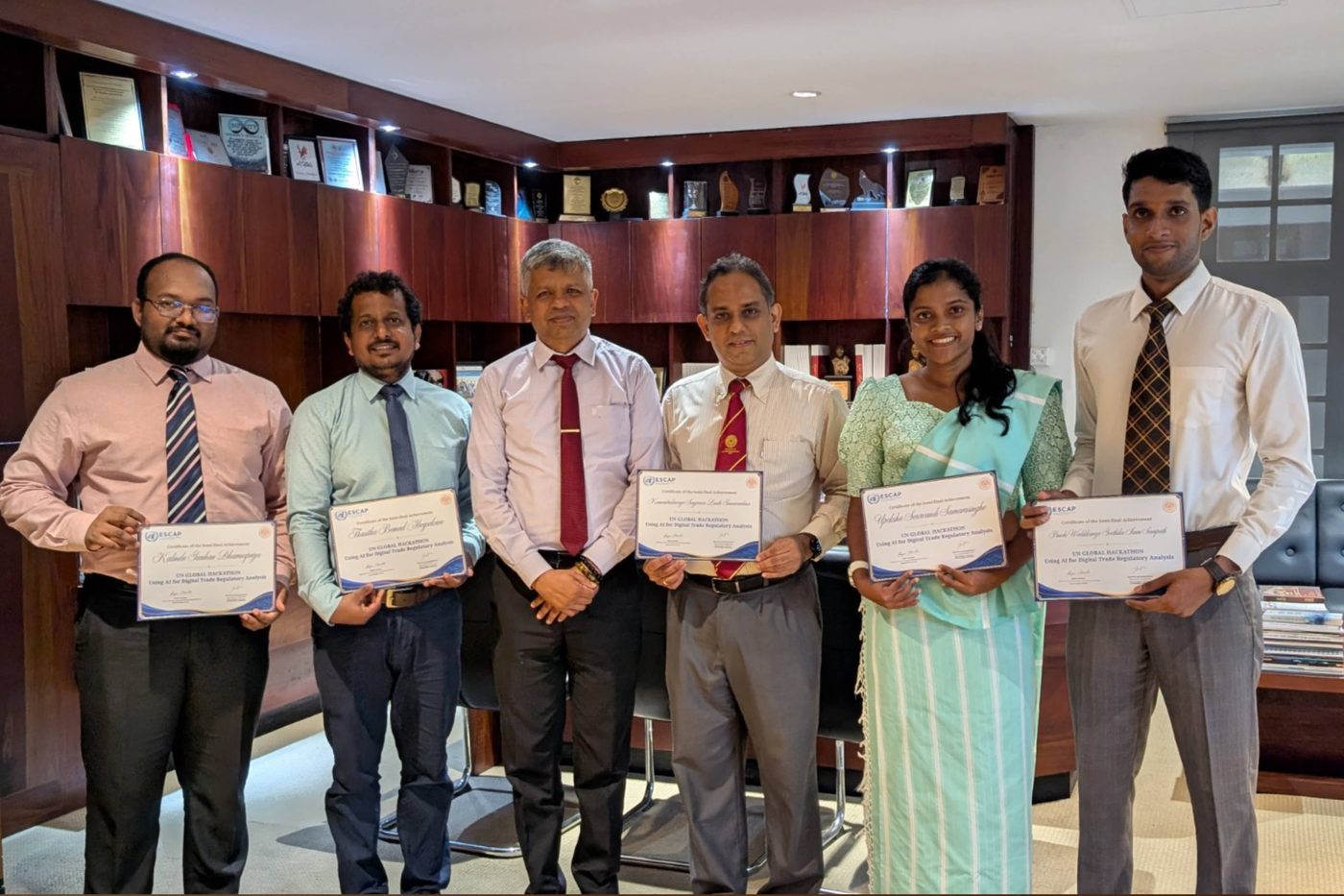 The TradeWise team holding their UN ESCAP Global Hackathon semi-final certificates at the University of Sri Jayewardenepura